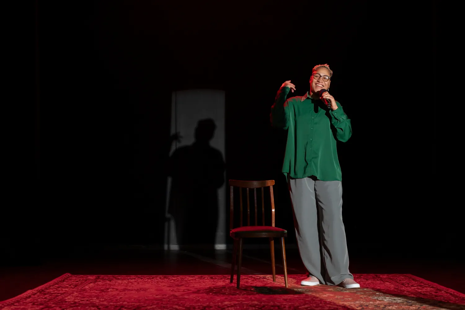 Black Woman on stage telling their story. 